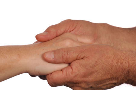 Man holds woman's hand tenderly