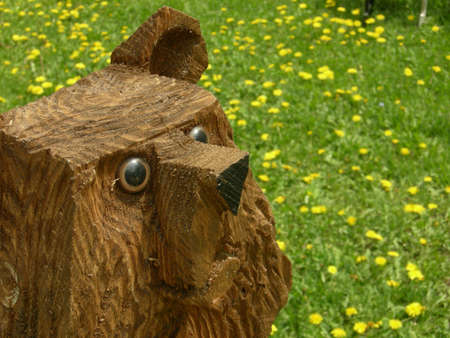 Wood sculpture of a bear with a goofy expressionの写真素材