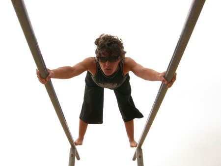 Woman balances on parallel barsの写真素材