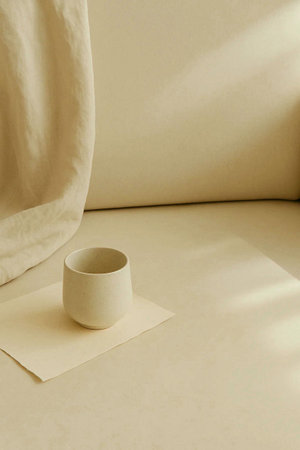 Ceramic cup on a beige background. Minimalism.の素材