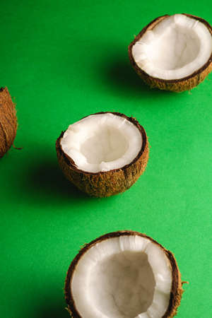 Coconut fruits on green plain background, abstract food tropical concept, angle viewの写真素材