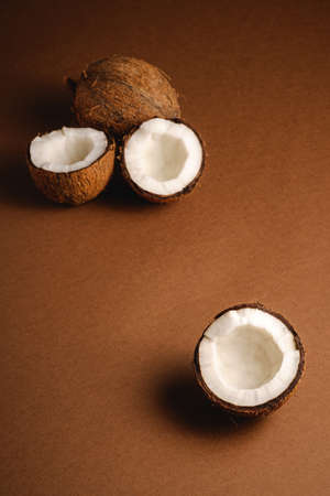 Coconut fruits on brown plain background, abstract food tropical concept, angle view copy spaceの写真素材