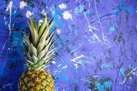 Fresh sweet pineapple on blue textured background, top view copy spaceの写真素材