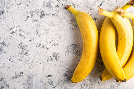 Banana fruits on white textured background, top view copy spaceの写真素材