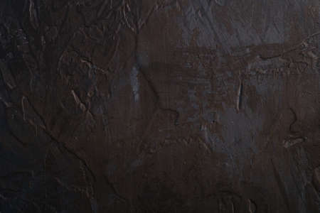 Photo of creative dark textured background in black, brown and blue grunge colors, paint and splash...