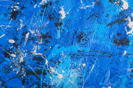 Photo of creative textured background in blue, black and white grunge colors, paint and splash drops backdropの写真素材