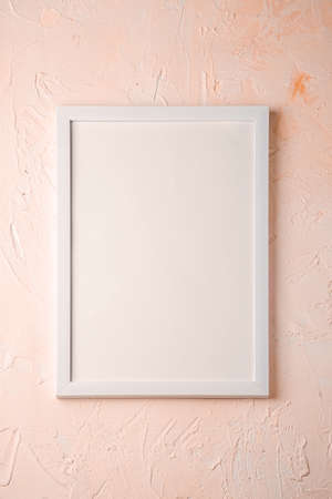 White empty template picture frame on textured bright, cream and peach background, top view, mockup copy spaceの写真素材