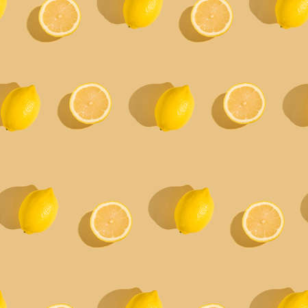 Lemon citrus fruits seamless pattern on cream yellow colored minimal background, tropical fresh juicy slicesの写真素材
