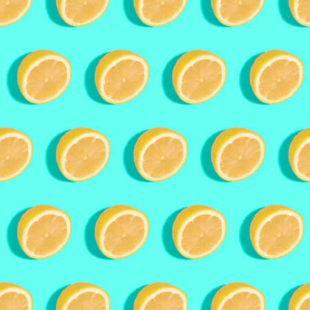 Lemon citrus fruits seamless pattern on green turquoise minimal background, tropical fresh juicy slicesの写真素材