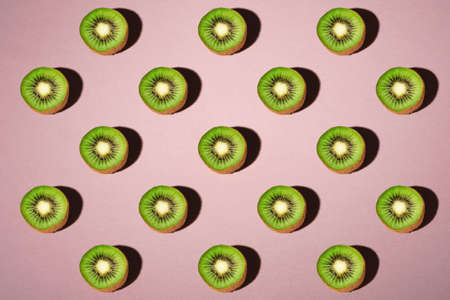 Kiwi fruits pattern on pastel pink backgroundの写真素材