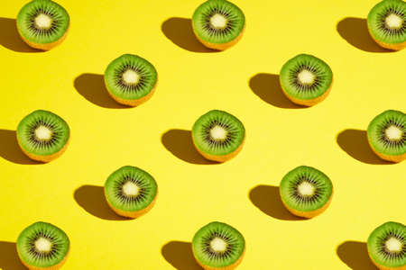 Kiwi fruits pattern on yellow backgroundの写真素材