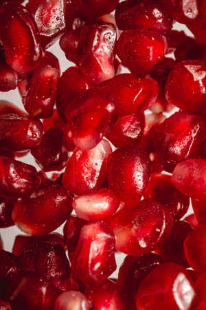 Fresh tasty sweet red peeled pomegranate seeds, macro texture, healthy food fruits, top view