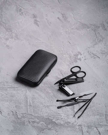 Set of manicure, pedicure tools and accessories with case, stone concrete background, angle viewの写真素材