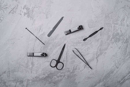Set of manicure, pedicure tools and accessories, stone concrete background, top viewの写真素材