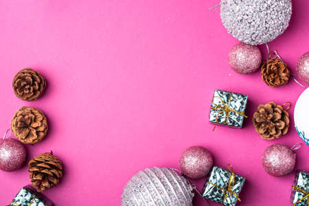 Christmas New Year composition. Gifts, fir tree cones, silver ball decorations on pink background. Winter holidays concept. Flat lay, top view, copy spaceの写真素材