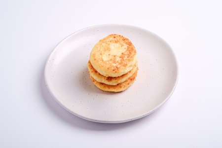 Cottage cheese fritters. Dessert breakfast in plate on white background, angle viewの写真素材