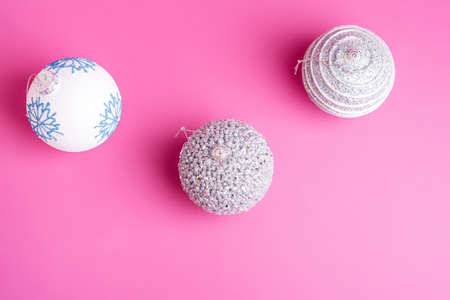 Christmas New Year composition. Gifts, silver and white ball decorations on pink background. Winter holidays concept. Top viewの写真素材