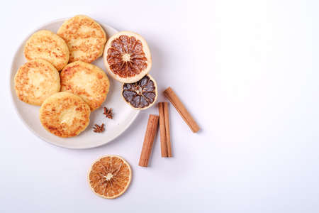 Cottage cheese fritters. Christmas breakfast mood with anise and cinnamon on white background, top...