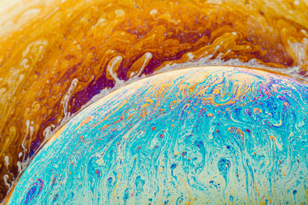 Fluid art made of colorful soap bubble film. Trendy Inkscape blurred background. Alien space planets art. Selective focus.の写真素材