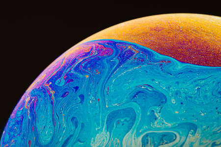 Fluid art made of colorful soap bubble film. Trendy Inkscape blurred background. Alien space planets...