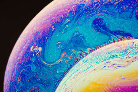 Fluid art made of colorful soap bubble film. Trendy Inkscape blurred background. Alien space planets art. Selective focus.の写真素材