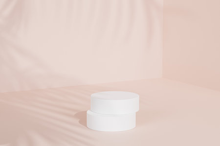 White podium or pedestal for products or advertising on beige background with tropical leaf shadow, 3d renderの写真素材