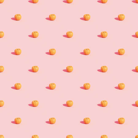 Pumpkins pattern on pink background for advertising on autumn holidays or sales, 3d renderの写真素材