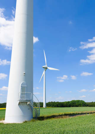 Wind generators under blue cloudy skyの写真素材