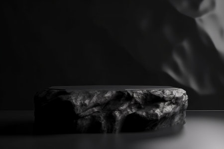 Dark rock podium for packaging and cosmetic presentation. Black and white stone display with abstract product placement. Realistic 3D rendering.の写真素材