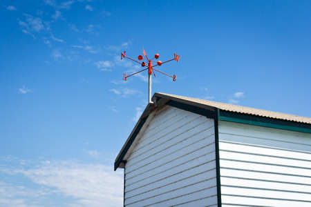red wind vane at the roof topの写真素材