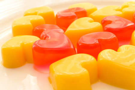 Plate of heart shaped jelly in red and yellowの写真素材