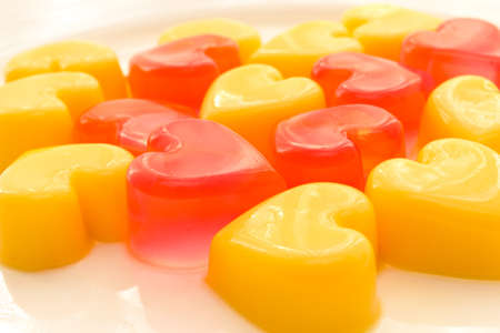Plate of heart shaped jelly in red and yellowの写真素材