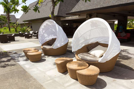Two round sofa chair made from bamboo with white tent cover on outdoor patioの写真素材