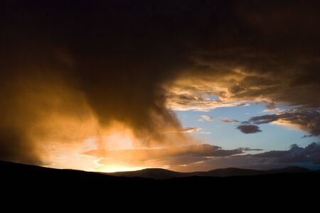 In Mongolia, sunset shines light through clouds, making them look like fireの写真素材