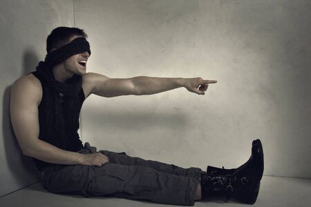 The short-sighted ignoramus in an empty grey room. A conceptual art photo.の写真素材