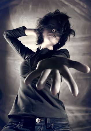 Sexy caucasian model posing against grey wall.