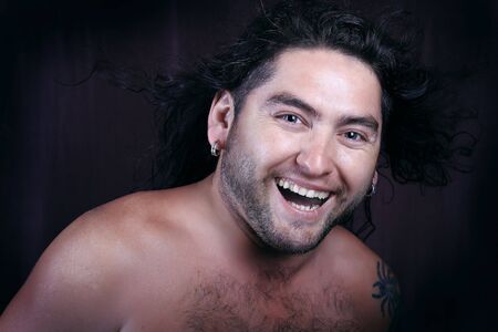 undressed long-haired macho with bristle on his face and hairy breast. の写真素材