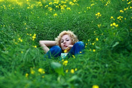 One young beautiful woman on a green meadow.
の写真素材