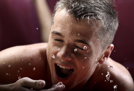 glamour portrait of the man on jets of water.の写真素材