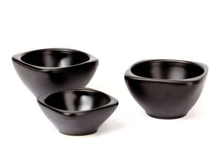 Black ceramic plates isolated on a white backgroundの写真素材