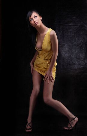 Young beauty brunet girl in yellow dressの写真素材