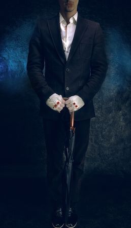 Young guy in suit with bandaged handsの写真素材