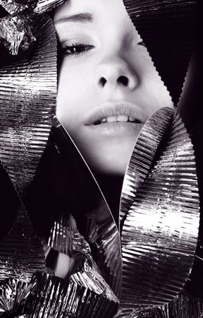 Young beautiful girl wound with red foilの写真素材