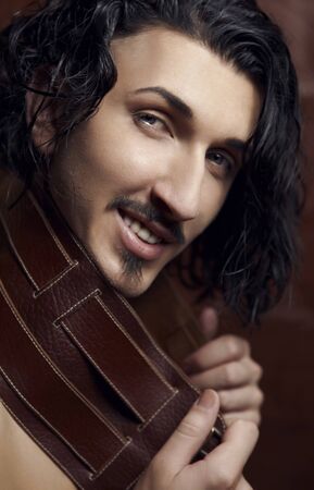 Portrait of young fashion macho. Close-up face.