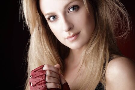 Portrait of attractive young blond smiling woman in sports gloves.の写真素材