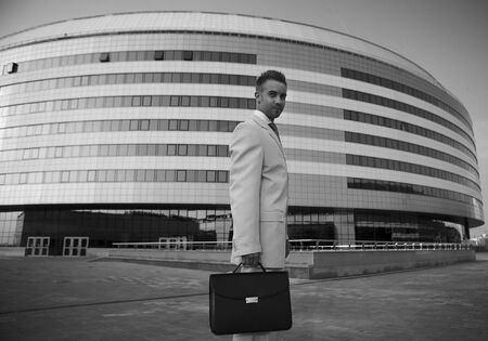 Young businessman portrait against urban backgroundの写真素材