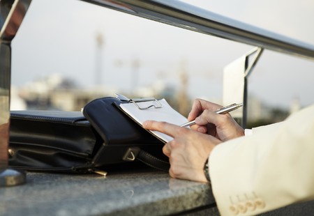 Young businessman working outdoorの写真素材