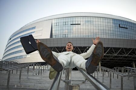 young businessman with briefcase running on stairの写真素材