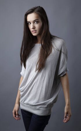 Sensual girl posing. Studio shot on gray background.の写真素材