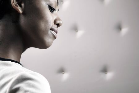 Close-up portrait of Beautiful African woman pose on a beige leather background.の写真素材